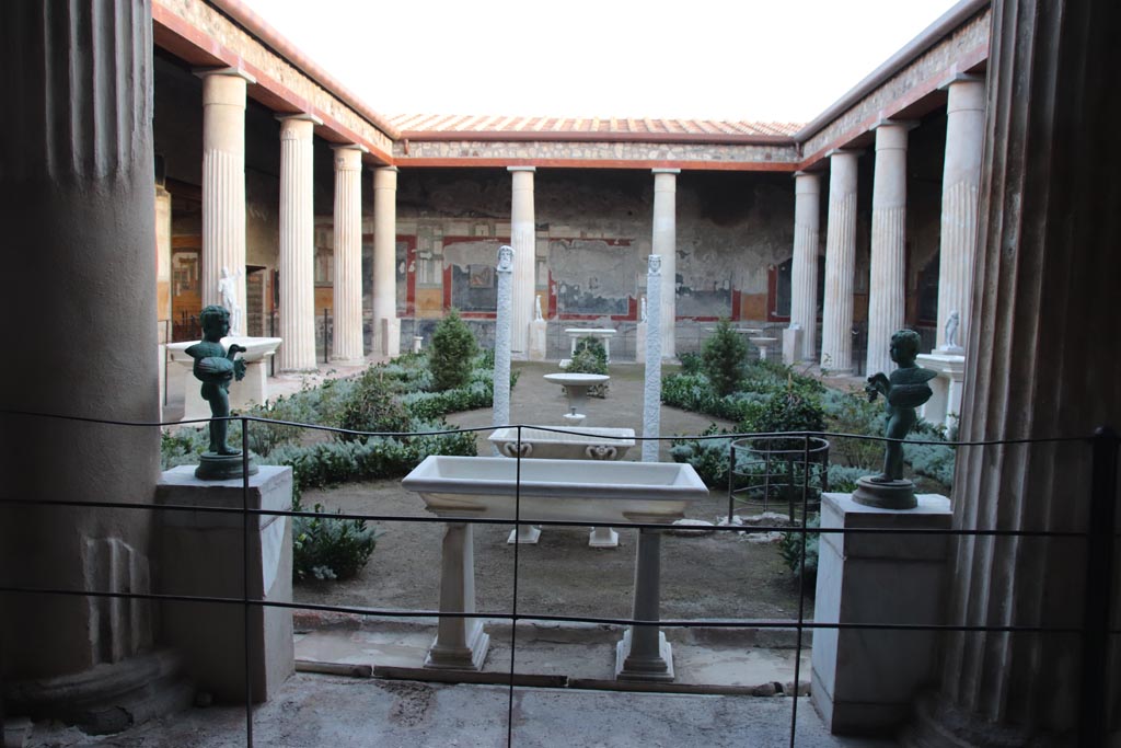 VI.15.1 Pompeii. October 2023. 
Looking south across peristyle garden from north portico outside of the “Cupid’s room”. Photo courtesy of Klaus Heese.
