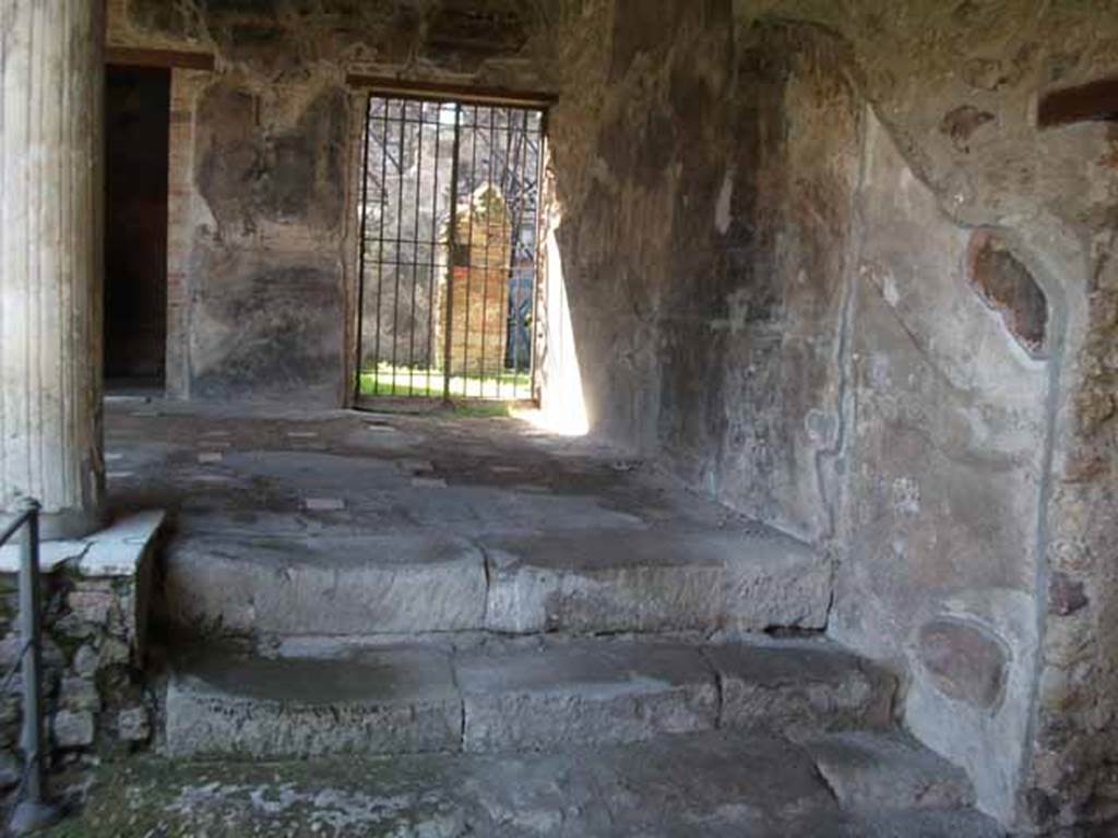 VI.16.7 Pompeii. May 2010. Looking west to doorway to services area from north-west corner of portico. 