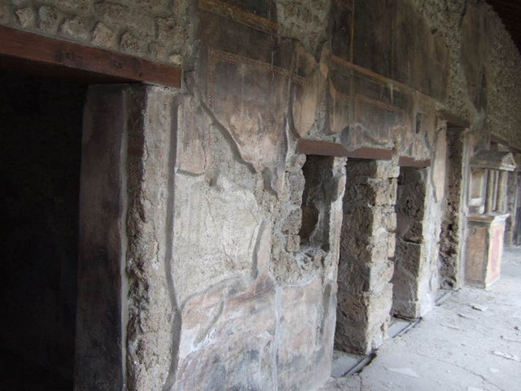 VI.16.7 Pompeii. May 2006. Room F, north portico. Looking east at doorways to rooms M, L, K, and J.