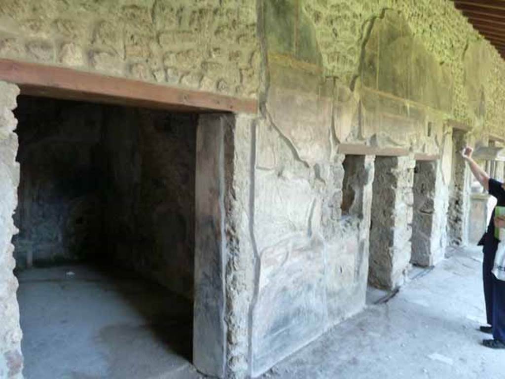 VI.16.7 Pompeii. May 2010. Looking east along north portico, with doorways to rooms M, L, K and J.