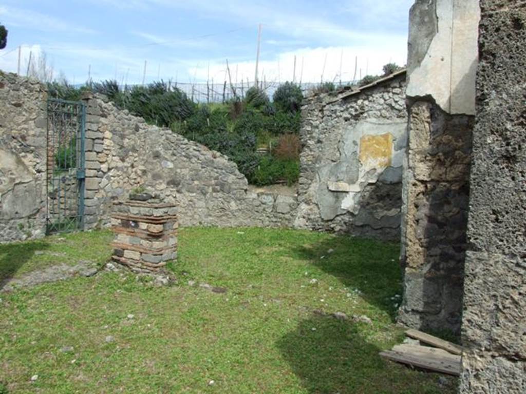 VI.16.27 Pompeii. March 2009. Room B, atrium.  Looking east to area that used to have a dividing wall (destroyed) and was originally two rooms I and J.  According to NdS, the doorway from room H (visible on the left) led into room I which was a type of ala. Room I would have been on the north-east of the atrium. On the north wall of room I, a painted dado was preserved, painted in imitation of a coating of coloured marble. On the south side of room I, was the large room J, its north wall was destroyed. Room J opened in its entire width onto the east side of the atrium. The wall decoration of first style was very notable, preserved on the south and east. In the main part of the walls, one saw large slabs of protruding stucco, painted in imitation of coloured marble. In the frieze were the usual smaller rectangles. The dado offered a decoration imitating a perspective of small cubes arranged in horizontal rows, one above the other, each with a protruding edge. The floor was of simple soil.

