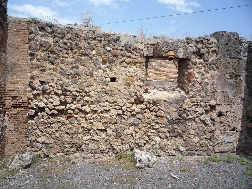 VII.1.36 Pompeii. October 2009. North wall with window onto Via degli Augustali, in room on east side of entrance corridor.
Photo courtesy of Jared Benton.
