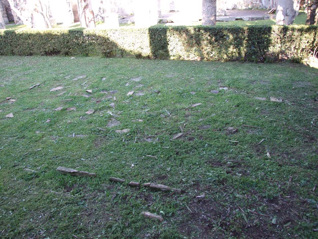 VII.4.31/51 Pompeii. March 2009. Remains of brick-edged flower beds in north peristyle garden. Looking east.