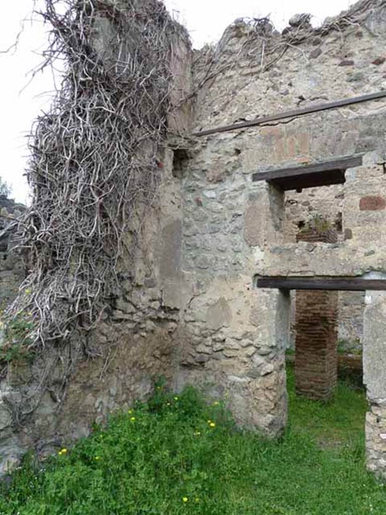 VII.4.39 Pompeii. May 2010. North-west corner of rear room, with door and window into workshop on north side.