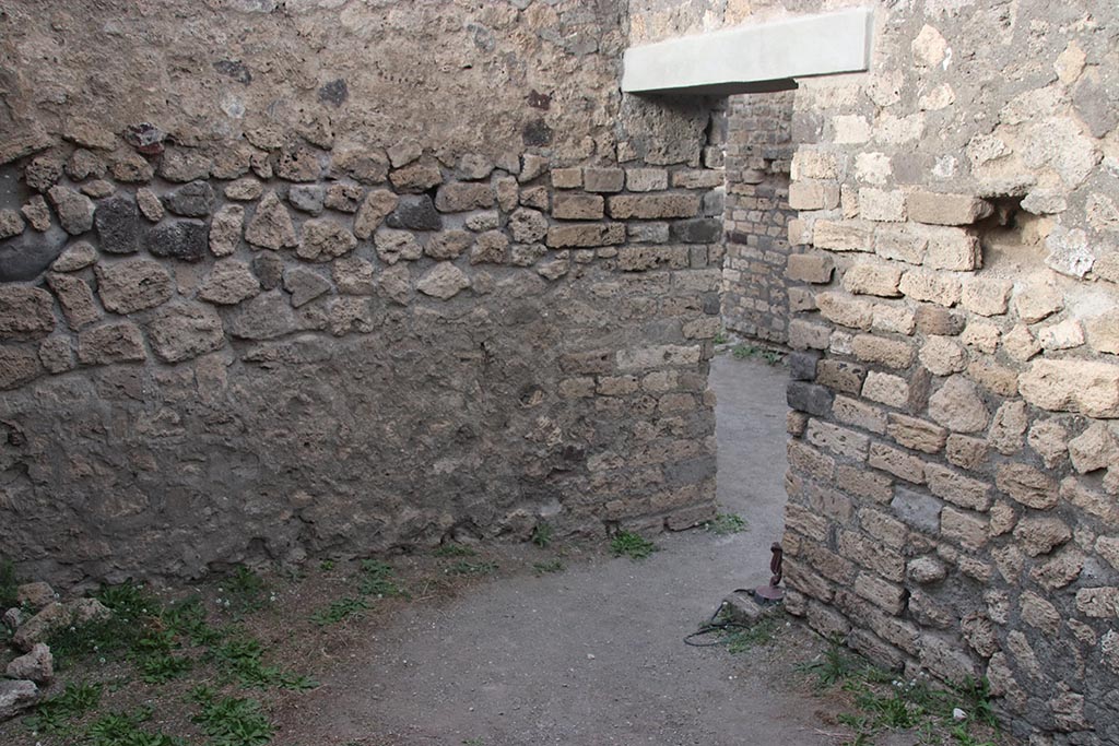 VII.7.2 Pompeii. October 2024. Room “b”, north wall and doorway to entrance corridor “a”, on right. Photo courtesy of Klaus Heese.