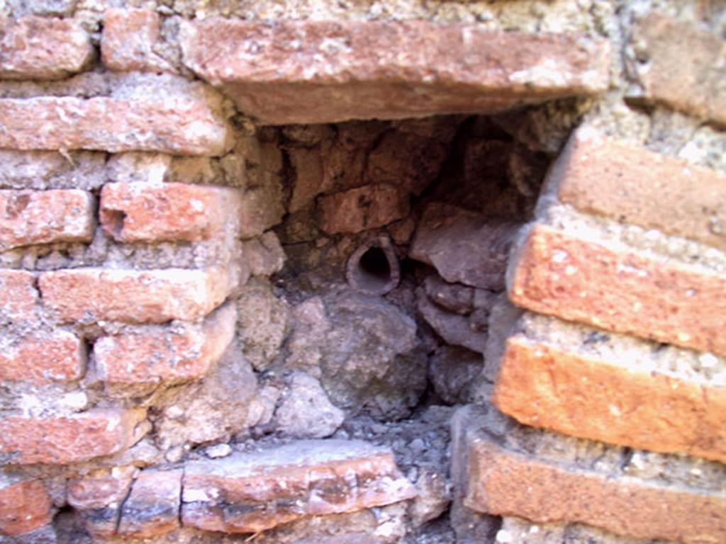 VII.12.11 Pompeii. July 2008. Recess and pipe on east side of oven. Photo courtesy of Jared Benton.