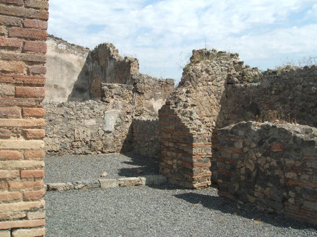 VII.14.6 Pompeii. May 2005. East wall with doorway to latrine under staircase at VII.14.7.

