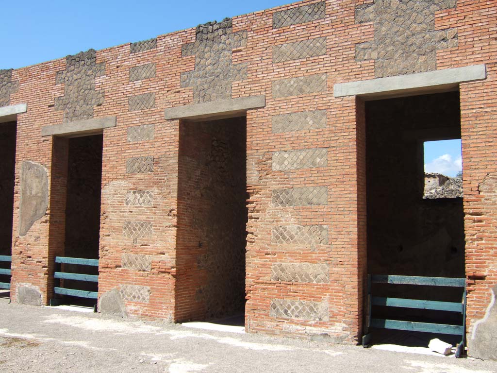 VIII.2.16 Pompeii. September 2005. Doorways on north side of atrium.
The central one leading to VIII.2.14, on the left of it is a cubiculum with windowed niche, and on the right of it is another cubiculum.  
