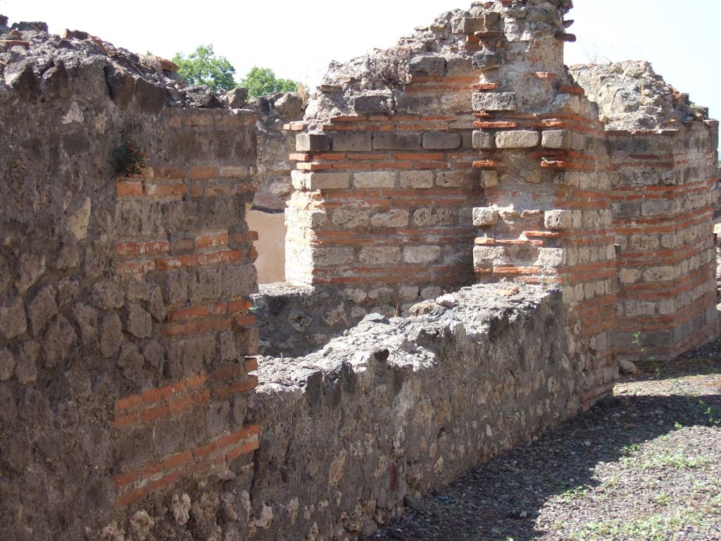 VIII.2.20 Pompeii. September 2005. Window of light-yard in south wall of corridor, with doorway to corridor on right.
According to Jashemski, this doorway/corridor would have led to the small peristyle which was on the street level.
It was enclosed on three sides by a portico supported by two pillars.
The black walls of the peristyle were beautifully painted with grape vines with clusters of fruit, many birds, lizards and a little mouse.
This garden was the centre of the house on this level.
See Jashemski, W. F., 1993. The Gardens of Pompeii, Volume II: Appendices. New York: Caratzas. (p.207)
