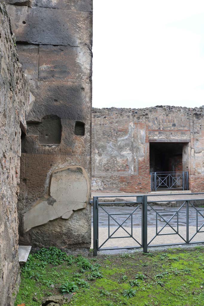 VIII.3.11, Pompeii., December 2018. 
Looking towards north-west corner with doorway to Via dell’Abbondanza, on right, and doorway to base of steps to upper floor in west wall, on left.  Photo courtesy of Aude Durand.
