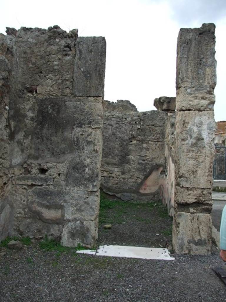 VIII.3.27 Pompeii. December 2007. Cubiculum to south of entrance fauces. Looking through doorway to north-west corner. In this room the floor was of cocciopesto which also had irregularly scattered black and white tesserae. In the west wall it used to be possible to see the slender candelabra design in the south panel of the side panels of the middle zone. In the north wall, the zoccolo was visible as well as the red middle zone but did not retain any details of the decorations. 

