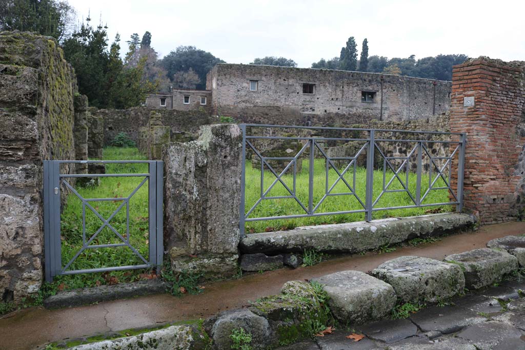 VIII.7.7 Pompeii, on left, and VIII.7.8. December 2018. 
Looking west to entrance doorways on Via Stabiana. Photo courtesy of Aude Durand.

