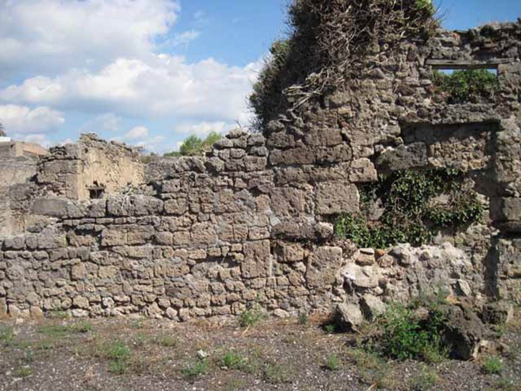 VIII.7.26 Pompeii. September 2010. Wall of east side of atrium, with window into triclinium. Photo courtesy of Drew Baker.
