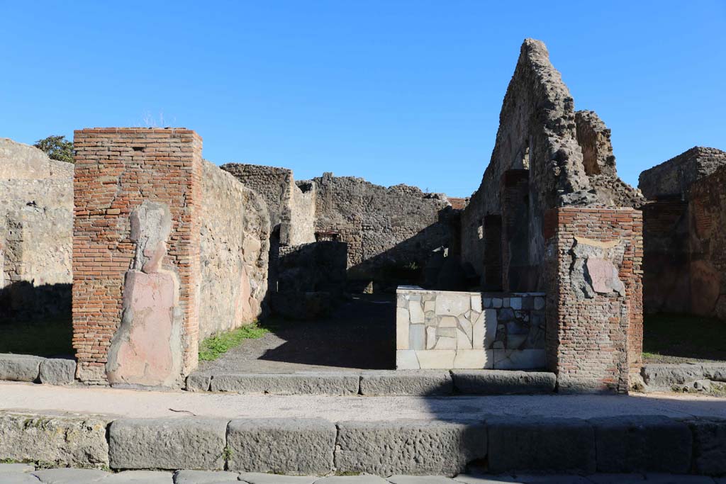 IX.1.3 Pompeii. December 2018. Looking east on Via Stabiana towards entrance doorway. Photo courtesy of Aude Durand.
In February 1852, found painted in red, on the pilaster between IX.1.2 and IX.1.3 (on the left) was the graffito:  
Vettium    [CIL IV 942]
See Pagano, M. and Prisciandaro, R., 2006. Studio sulle provenienze degli oggetti rinvenuti negli scavi borbonici del regno di Napoli. Naples: Nicola Longobardi. (p.167) 
