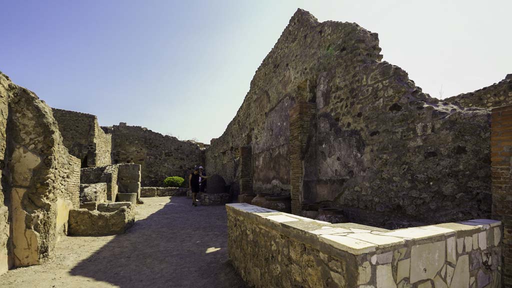 IX.1.3 Pompeii. August 2021. Looking east across shop towards bakery at rear, from entrance doorway. Photo courtesy of Robert Hanson.