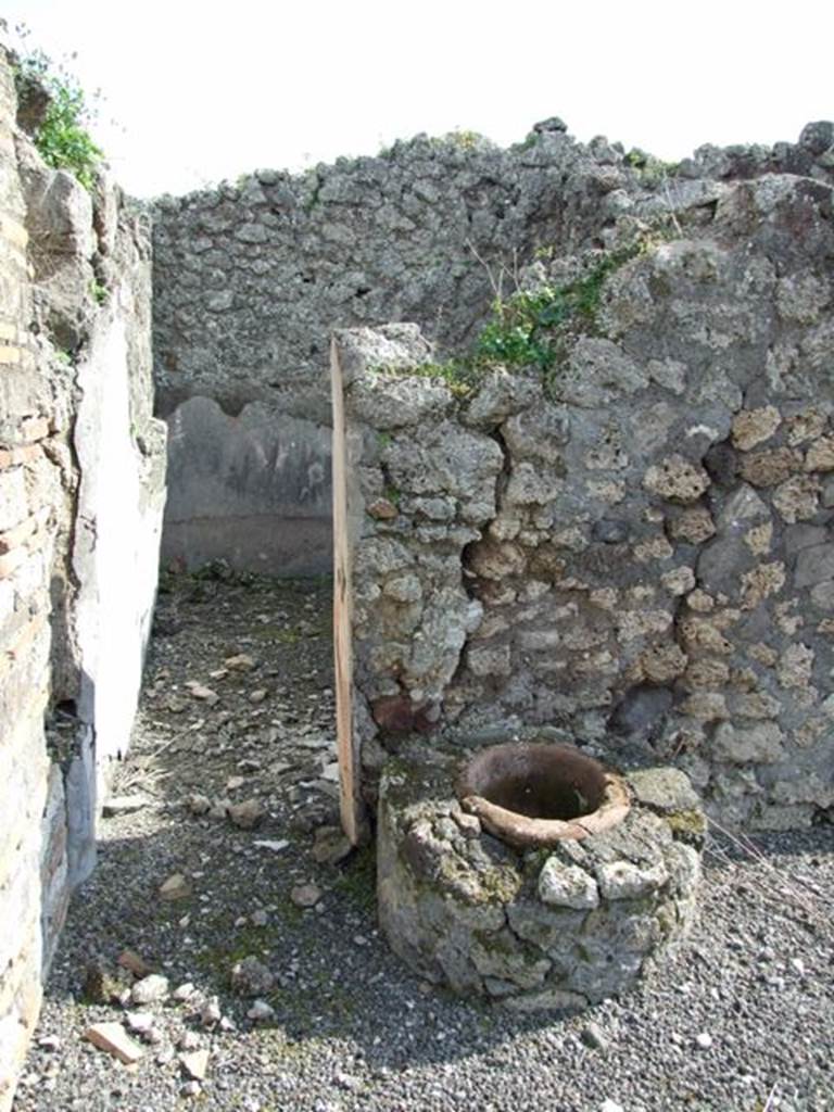 IX.2.18 Pompeii. March 2009. Doorway to room 6, cubiculum, looking south. On the right of the doorway is the terracotta mouth of the well built into masonry brickwork. 
