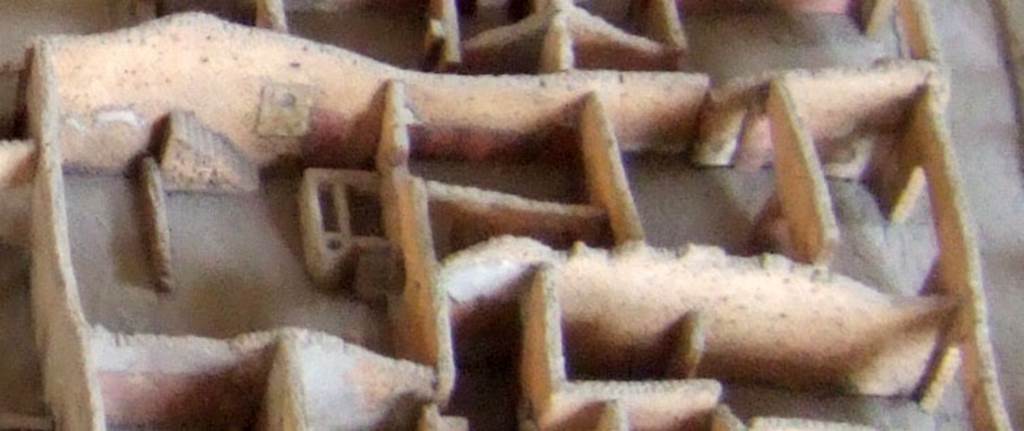 Part of the cork model of Pompeii in the Naples Archaeological Museum showing IX.2.24. The yard on the left shows the staircase and the Lararium referred to by Frhlich. See Frhlich, T., 1991, Lararien und Fassadenbilder in den Vesuvstdten.  Mainz: von Zabern.  (L99: p.293, T. 42,3). 