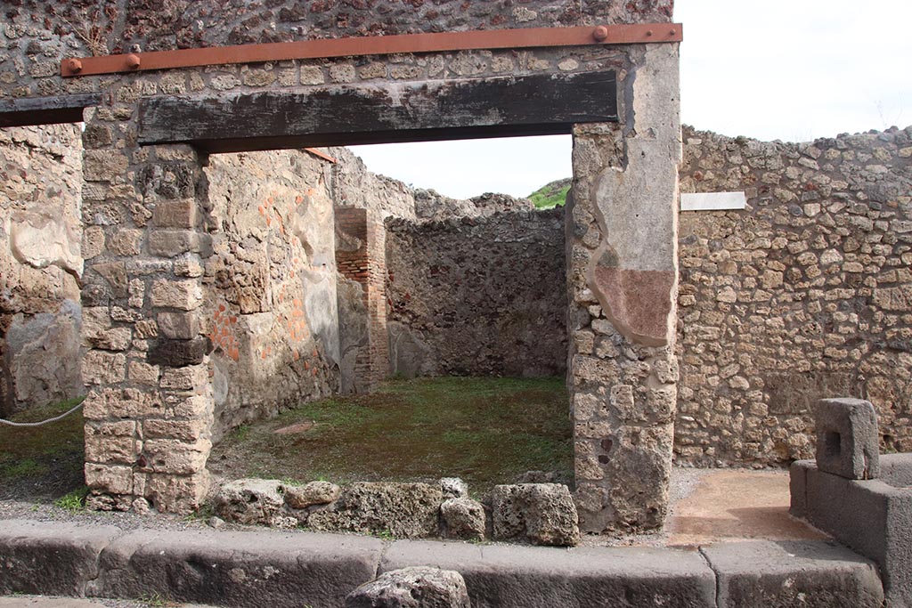 IX.7.18 Pompeii. October 2024. Looking east towards entrance doorway on Vicolo di Tesmo. Photo courtesy of Klaus Heese.