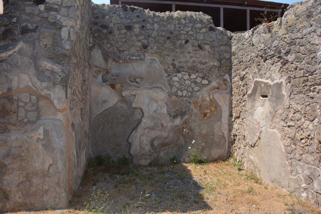 IX.7.19 Pompeii. July 2017. Looking north in ala c
Foto Annette Haug, ERC Grant 681269 DÉCOR.

According to Mau, when excavated the following paintings were found on the walls of this room.
Room c, the ala:
In the middle of the back (north) wall, - fish and shells in water (size: height 0.23m x length 0.31m - the right side was missing (half destroyed, according to Not. di Scavi, 1880, p.491).
On the sides of the back (north) wall – medallions enclosed in garlands (size: 0.20) –
on the left was the head of Diana crowned with leaves, with two javelins. She had dark hair with a narrow necklace around her neck and was wearing a red tunic buckled above both shoulders with a gold coloured buckle.
on the right was the head of Helios, with halo and blue rays, with a whip on the right shoulder. He had long blonde hair and was dressed the same as Diana.
On the right (east) wall, the remains of a destroyed lararium painting was found.
See Mau, in Bullettino dell’Instituto di Corrispondenza Archeologica (DAIR), 1883, (p.79).
See Sogliano, in Notizie degli Scavi di Antichità, 1880, (p.491).


According to Mau, when excavated the following paintings were found on the walls of this room.
Room c, the ala:
In the middle of the back (north) wall, - fish and shells in water (size: height 0.23m x length 0.31m - the right side was missing (half destroyed, according to Not.di Scavi, 1880, p.491).
On the sides of the back (north) wall – medallions enclosed in garlands (size: 0.20) –
on the left was the head of Diana crowned with leaves, with two javelins. She had dark hair with a narrow necklace around her neck and was wearing a red tunic buckled above both shoulders with a gold coloured buckle.
on the right was the head of Helios, with halo and blue rays, with a whip on the right shoulder. He had long blonde hair and was dressed the same as Diana.
On the right (east) wall, the remains of a destroyed lararium painting was found.
See Mau, in Bullettino dell’Instituto di Corrispondenza Archeologica (DAIR), 1883, (p.79).
See Sogliano, in Notizie degli Scavi di Antichità, 1880, (p.491).
According to Boyce, on the east wall of the left ala, a fragment of a lararium painting was seen at the time of excavation.
The fragment represented a single serpent moving amongst foliage.
See Boyce G. K., 1937. Corpus of the Lararia of Pompeii. Rome: MAAR 14. (p.88, no.437)  
See Fröhlich, T., 1991. Lararien und Fassadenbilder in den Vesuvstädten. Mainz: von Zabern. (p.112)
