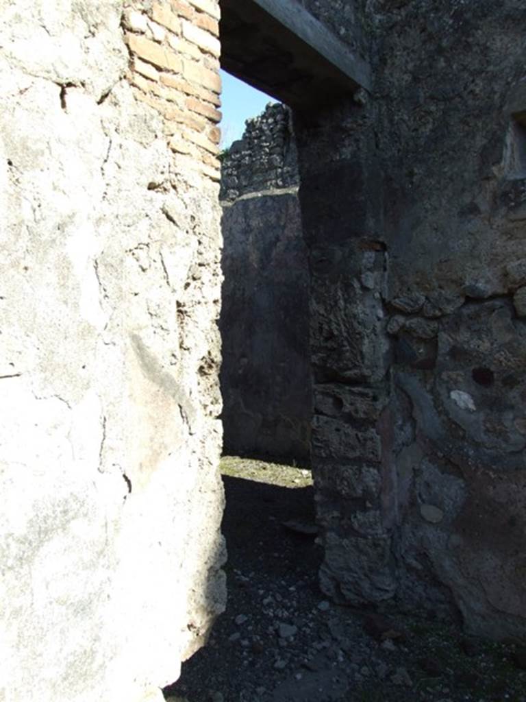 IX.9.d Pompeii. March 2009. Doorway to room l, triclinium or oecus. According to NdS, this room was an oecus which had not been entirely excavated (in 1889). The floor was of signinum, and the walls were red. The central panel on each wall was black, and each of these panels contained a painting with a black background.
