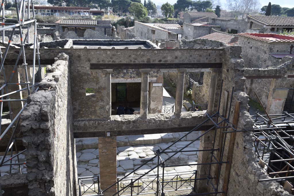 IX.12.2 Pompeii, on left, doorway to stairs to upper floor, with IX.12.1, entrance into room “a”, in centre. February 2017. 
Looking south across Via dell’Abbondanza. Photo courtesy of Johannes Eber.

