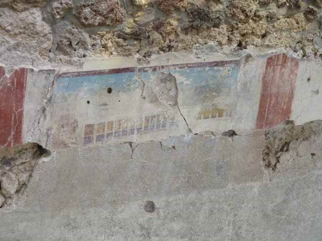 IX.12.4 Pompeii. May 2010. Room “f”, detail of painted east wall in room being excavated, on west side of bakery at IX.12.6. 
