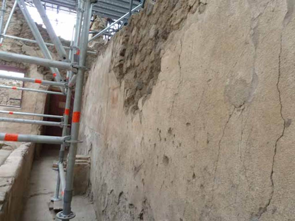 IX.12.6 Pompeii. May 2010. Room “n1”, looking south along west wall with lararium painting above the altar.