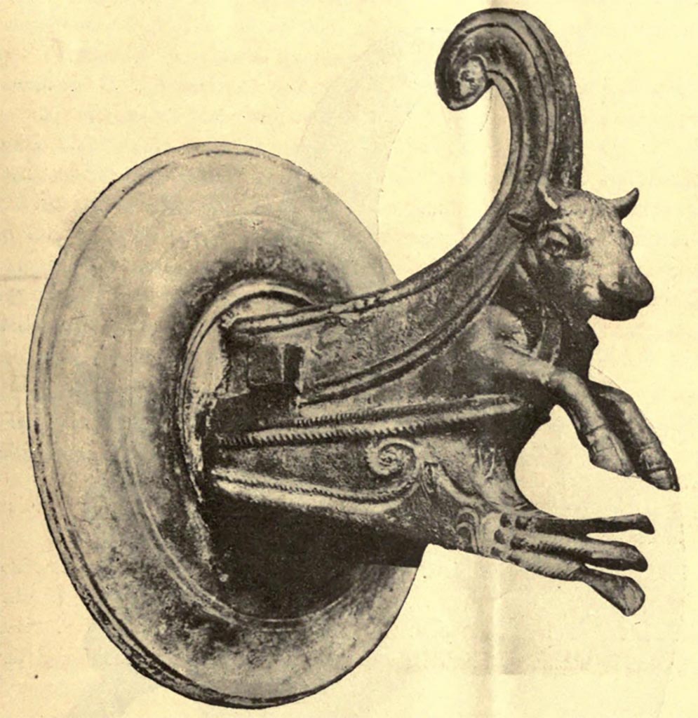 IX.14.4 Pompeii. 
One of a pair of bronze fittings (borchia figurata), from south wall of atrium B.
See Notizie degli Scavi di Antichità, 1905, (p. 255, fig.7)
