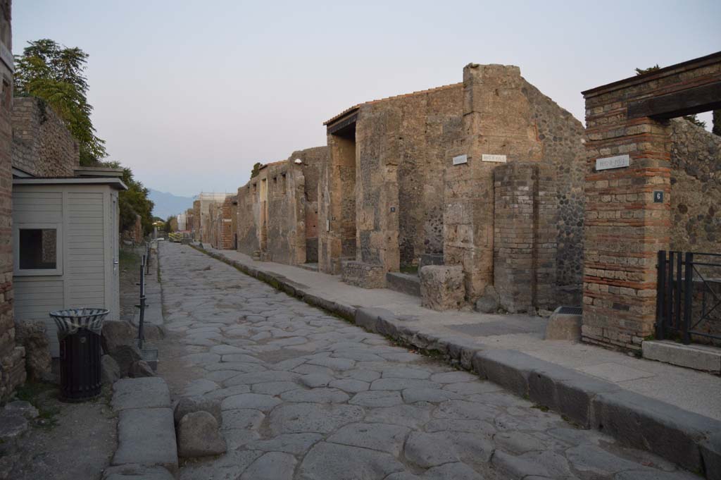 Via dell’Abbondanza, south side. May 2010. Looking south past water tower along Vicolo di Octavius Quartio, between II.2 and II.1.