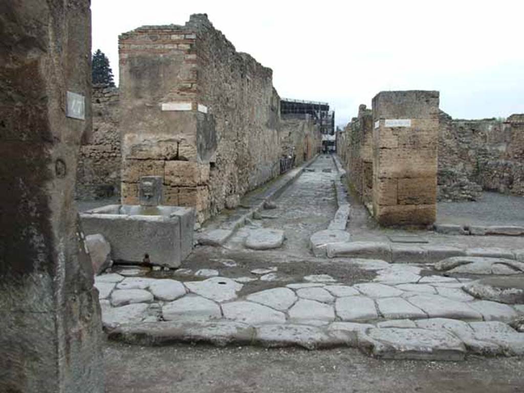 Via della Fortuna, north side, May 2010. Looking north across junction with Vicolo dei Vettii, from VII.4.47.