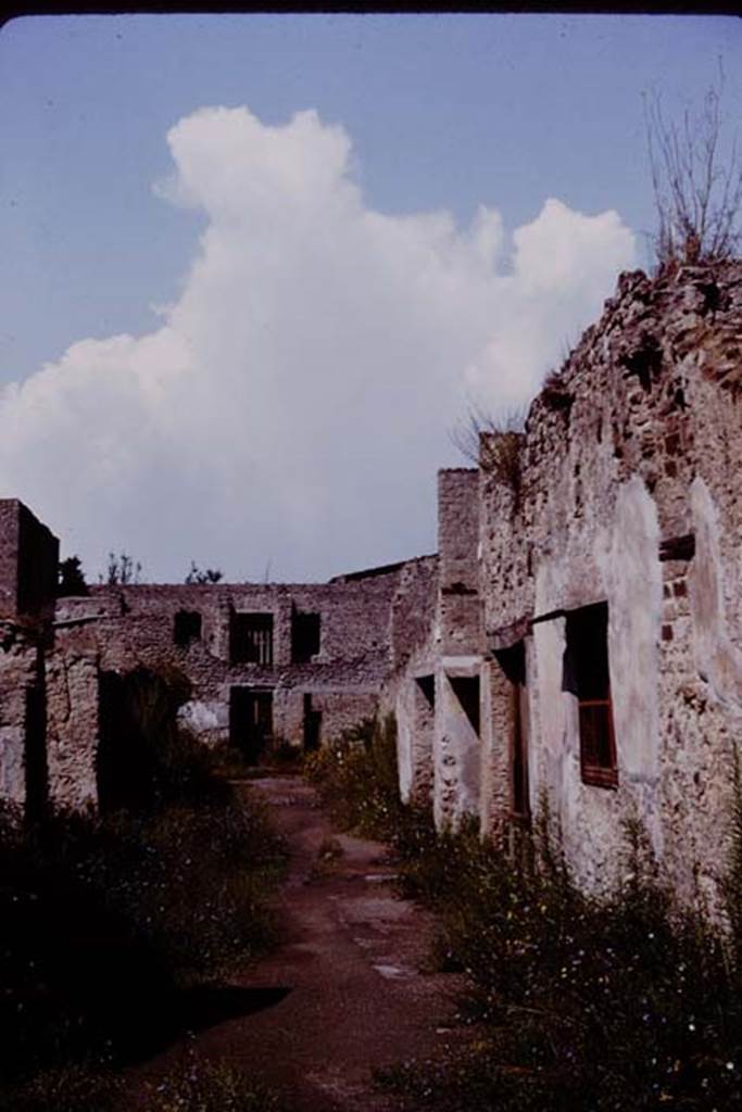 Via di Castricio, Pompeii. 1964. 
Looking west towards junction with Vicolo di Paquius Proculus, from between I.19/I.18, on left and I.7/I.8, on right.
Photo by Stanley A. Jashemski.
Source: The Wilhelmina and Stanley A. Jashemski archive in the University of Maryland Library, Special Collections (See collection page) and made available under the Creative Commons Attribution-Non-Commercial License v.4. See Licence and use details.
J64f1940

