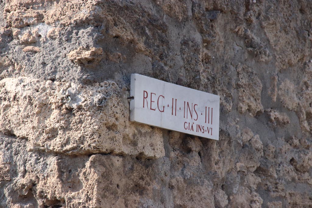 Vicolo di Giulia Felice, west side, Pompeii. October 2023. Insula identification plaque originally known as II.6. Photo courtesy of Klaus Heese.