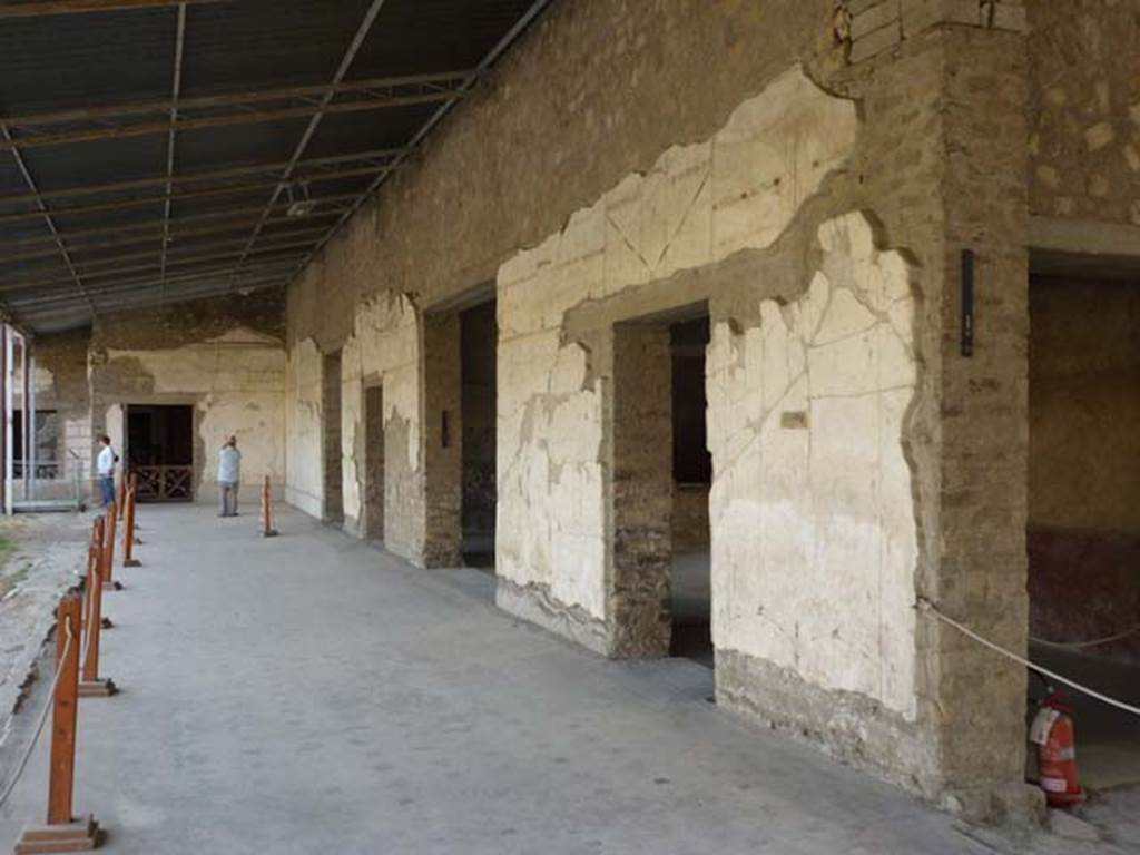 Oplontis, September 2011. Portico 60, looking south along portico on west side of swimming pool. At the far end is the doorway to room 66, then in the west wall are the doorways to rooms 46, 63, 65, and on the right, two doors of room 75. Photo courtesy of Michael Binns.
